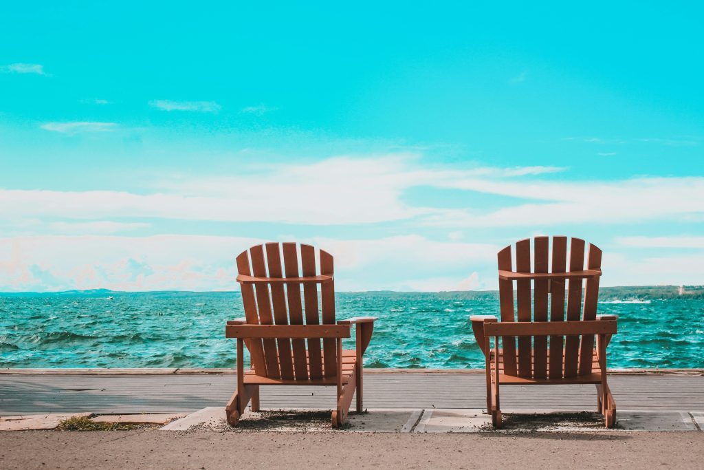 Adirondack chairs overlooking a lake